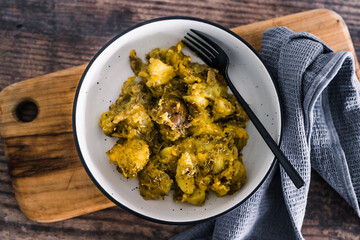 vegan oven baked smashed potatoes with pesto sauce and plant-based cheese, healthy plant-based food