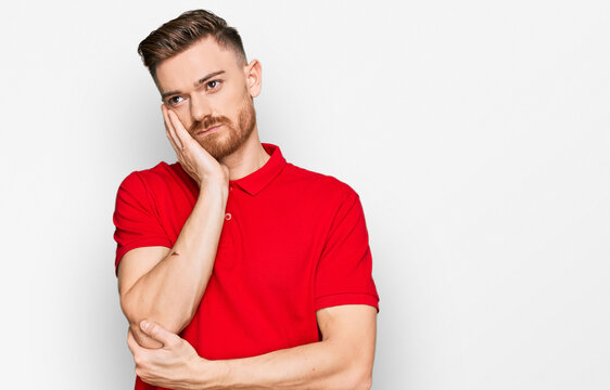 Young redhead man wearing casual clothes thinking looking tired and bored with depression problems with crossed arms.