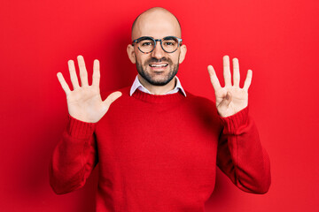 Young bald man wearing casual clothes and glasses showing and pointing up with fingers number nine...