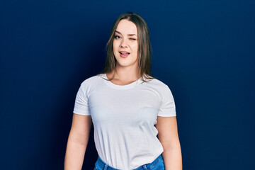 Young hispanic girl wearing casual white t shirt winking looking at the camera with sexy...