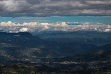 Fototapeta premium Stunning scene of Colombian andean mountains with green valley and blue cloudy landscape