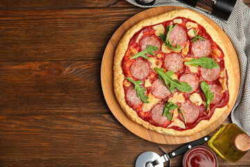 Delicious homemade pita pizza on wooden table, flat lay. Space for text
