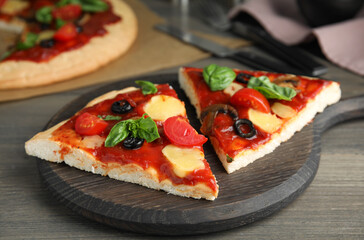 Slices of delicious pita pizza on wooden table
