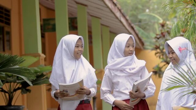 a portrait of a muslim school student having discussion in school garden