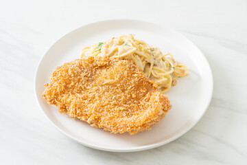 spaghetti pasta white cream sauce with fried fish