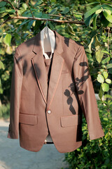 brown suit hanging on the tree