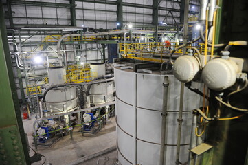 Pavlodar region, Kazakhstan - 12.10.2015 : Pipes and tanks with a centrifuge for processing sulfide...
