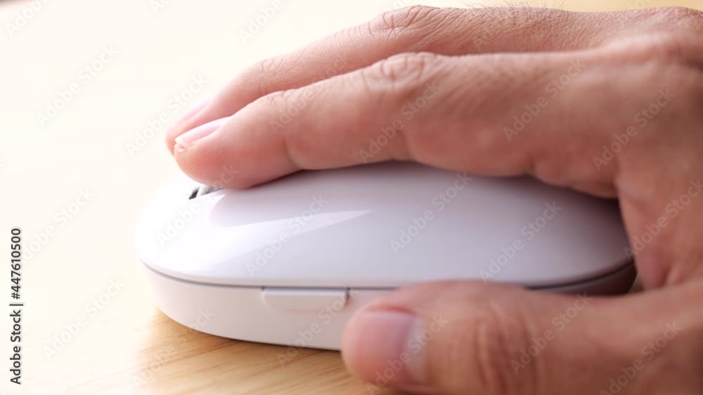 Poster static shot of a hand moving and clicking a mouse in slow motion