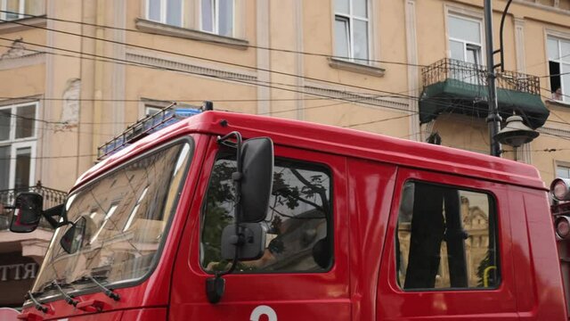 Fire truck pulls up to scene accident at day lights. Firetruck driving on road