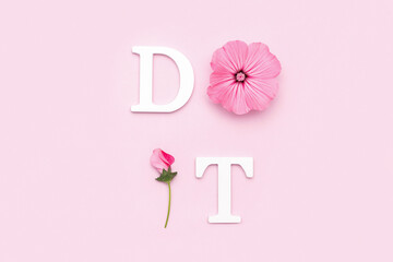Do it. Motivational quote from white letters and beauty natural flowers on pink background. Creative concept inspirational quote of the day