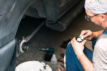 Auto mechanic repairing the brake system of car