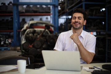Businessman using laptop computer working or checking stock in warehouse factory, entrepreneurship or business owner concept