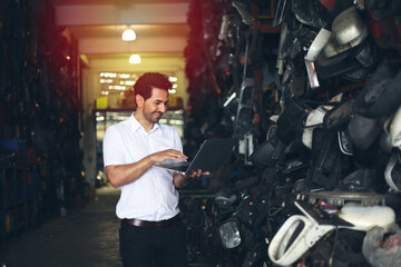 Fototapeta na wymiar Worker or Engineer work in factory and talk with team by radio, Check stock and inspection in machine spare part engine warehouse