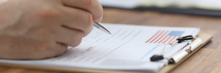 Man filling out documents for US visa closeup