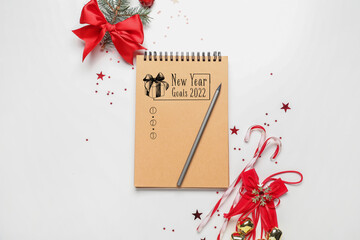 Notebook with empty to-do list for 2022 year and Christmas decor on light background