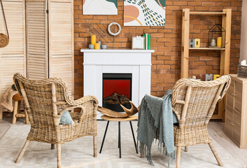 Interior of stylish room with fireplace and folding screen