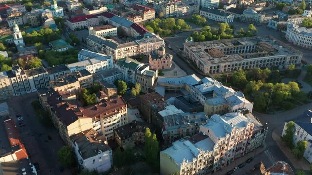 Aerial view of church and cyti. City At Sunset. Aerial view of small old european town. Aerial panoramic view of historic brick buildings. 
