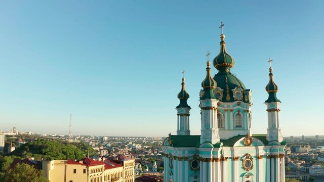 Aerial view of church and cyti. City At Sunset. Aerial view of small old european town. Aerial panoramic view of historic brick buildings. 