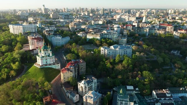 Aerial view of church and cyti. City At Sunset. Aerial view of small old european town. Aerial panoramic view of historic brick buildings. 