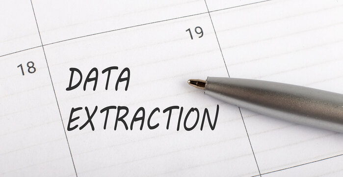 Text DATA EXTRACTION on calendar planner to remind you an important appointment with pen on isolated white background.
