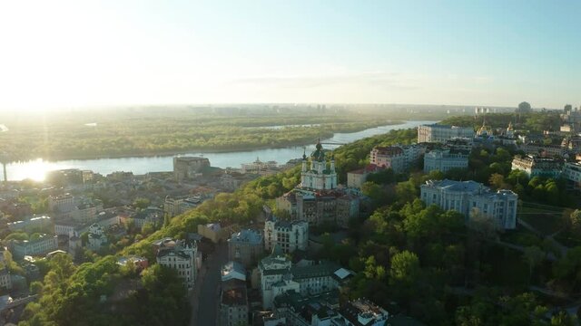 Aerial view of church and cyti. City At Sunset. Aerial view of small old european town. Aerial panoramic view of historic brick buildings. 