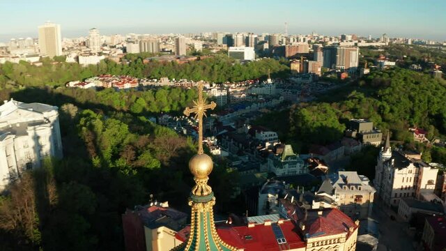 Aerial view of church and cyti. City At Sunset. Aerial view of small old european town. Aerial panoramic view of historic brick buildings. 