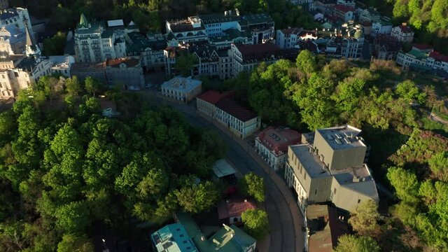 Aerial view of church and cyti. City At Sunset. Aerial view of small old european town. Aerial panoramic view of historic brick buildings. 