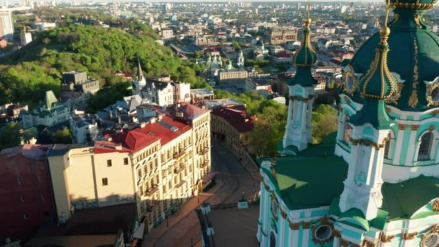 Aerial view of church and cyti. City At Sunset. Aerial view of small old european town. Aerial panoramic view of historic brick buildings. 