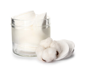 Glass jar with cotton pads on white background