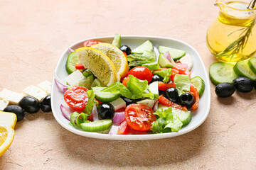 Plate with tasty Greek salad on color background, closeup