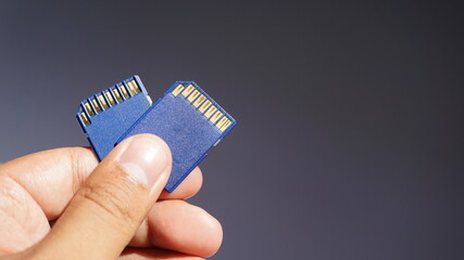 Hand holding blue sd cards 