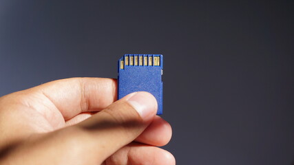 Hand holding blue sd cards 