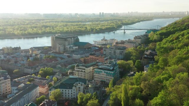Aerial view of church and cyti. City At Sunset. Aerial view of small old european town. Aerial panoramic view of historic brick buildings. 
