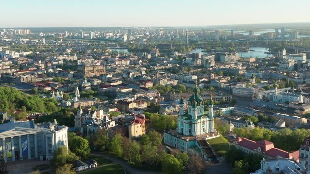 Aerial view of church and cyti. City At Sunset. Aerial view of small old european town. Aerial panoramic view of historic brick buildings. 