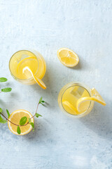 Lemonade. Homemade fresh ice tea with lemon and mint, shot from the top on a grey slate background with copy space