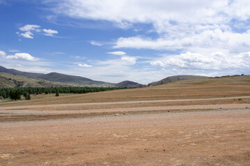 small hills and steppe against the background of the cloudy sky
