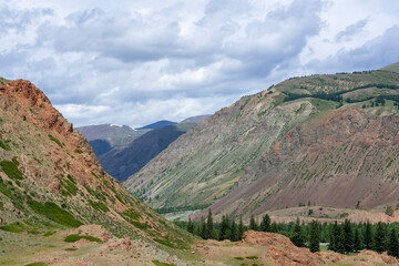 mountain peaks against the backdrop of a cloudy sky