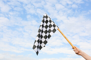 Woman with racing flag outdoors