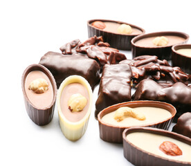 Different chocolate candies on white background, closeup