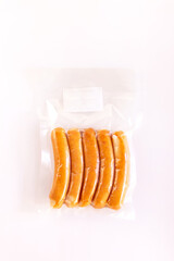Chicken sausage in vacuum package isolated on white background.