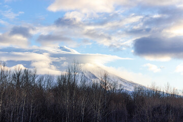The Koryaksky volcano is covered with clouds at sunrise. still considered as acting volcano.