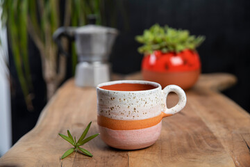 coffee cups with mocha pot on a wooden table