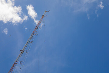 radio transmission towers in the city behind the bright sky