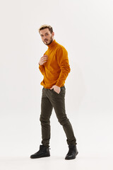 Naklejka premium bearded man in sweater hand in pocket posing clothes studio