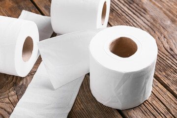Rolls of toilet paper on wooden background
