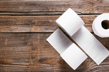 Rolls of toilet paper on wooden background