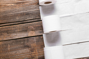Rolls of toilet paper on wooden background