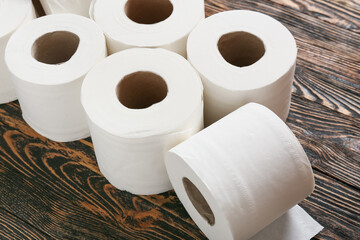 Rolls of toilet paper on wooden background