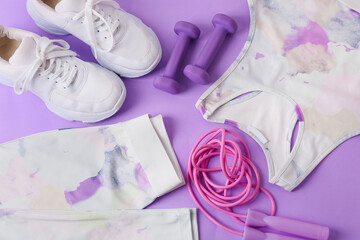 Sportswear and equipment on color background, closeup