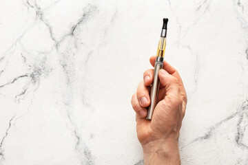 Male hand with electronic cigarette on white background